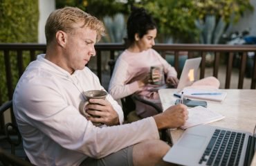 pexels-photo-6517274-6517274 A couple working together on their laptops while enjoying a coffee outdoors.